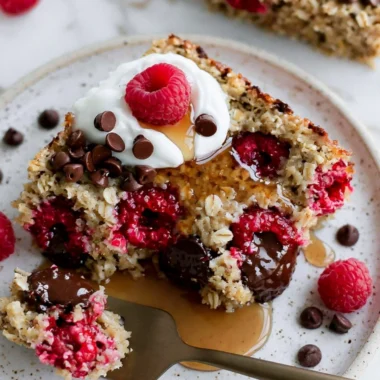 Cozy raspberry chocolate chip baked oatmeal in a baking dish