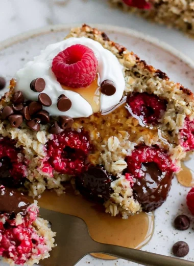 Cozy raspberry chocolate chip baked oatmeal in a baking dish