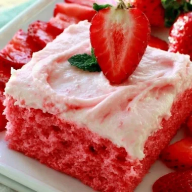 Deliciously moist strawberry sheet cake with fresh strawberries and frosting