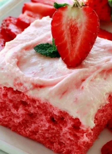 Deliciously moist strawberry sheet cake with fresh strawberries and frosting