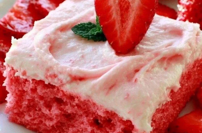 Deliciously moist strawberry sheet cake with fresh strawberries and frosting