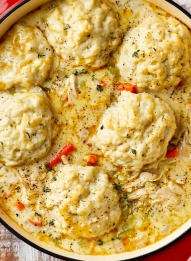 Bowl of creamy homemade chicken and dumplings with vegetables and herbs