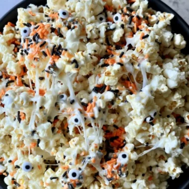 Colorful Halloween popcorn mixed with candy, perfect for spooky celebrations.