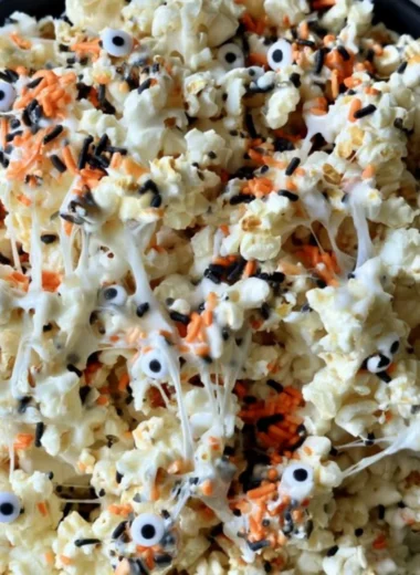 Colorful Halloween popcorn mixed with candy, perfect for spooky celebrations.