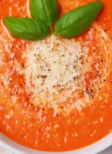 Bowl of high protein tomato soup garnished with herbs and spices