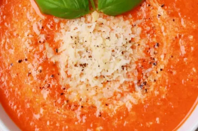 Bowl of high protein tomato soup garnished with herbs and spices