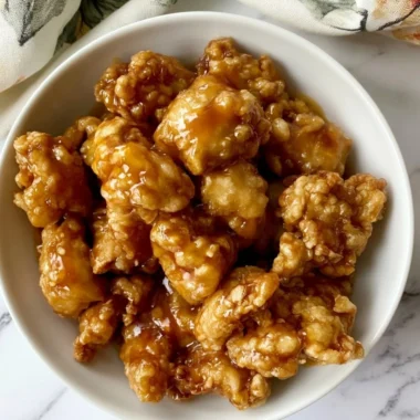 Delicious bowl of Panda Express Orange Chicken with rice and vegetables