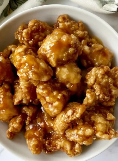 Delicious bowl of Panda Express Orange Chicken with rice and vegetables