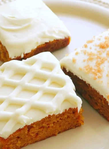 Delicious pumpkin bars with cream cheese frosting on a plate