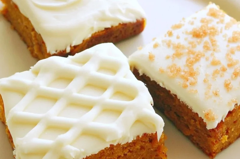 Delicious pumpkin bars with cream cheese frosting on a plate