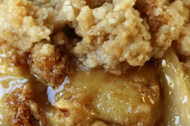 Delicious apple pear walnut crisp served in a bowl with a scoop of ice cream