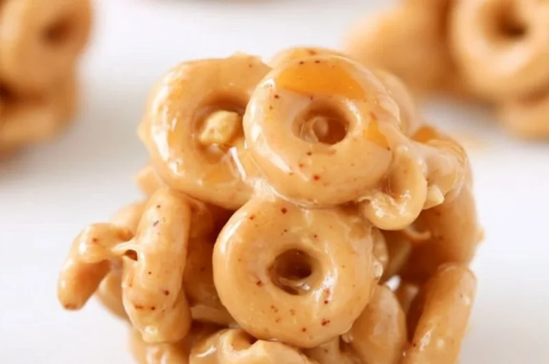 Delicious Peanut Butter Cereal Bites on a wooden table with a bowl of cereal.