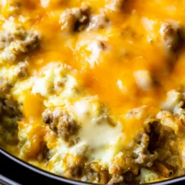 Delicious Cheesy Sausage Hashbrown Breakfast served with eggs