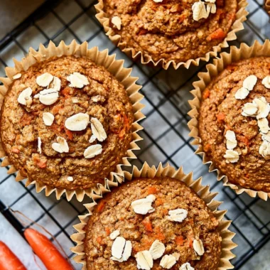 Freshly baked carrot apple muffins on a cooling rack