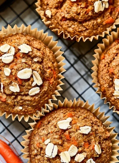 Freshly baked carrot apple muffins on a cooling rack