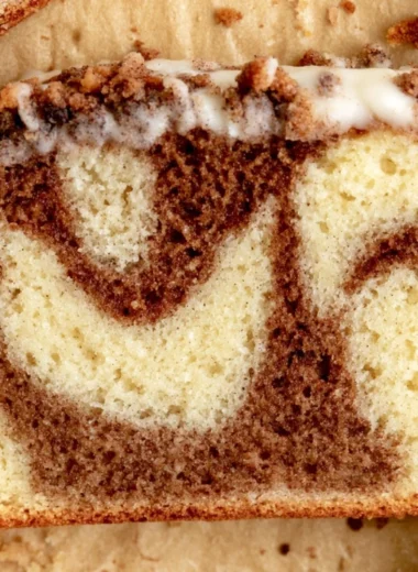 Deliciously baked cozy cinnamon loaf cake garnished with cinnamon sticks.