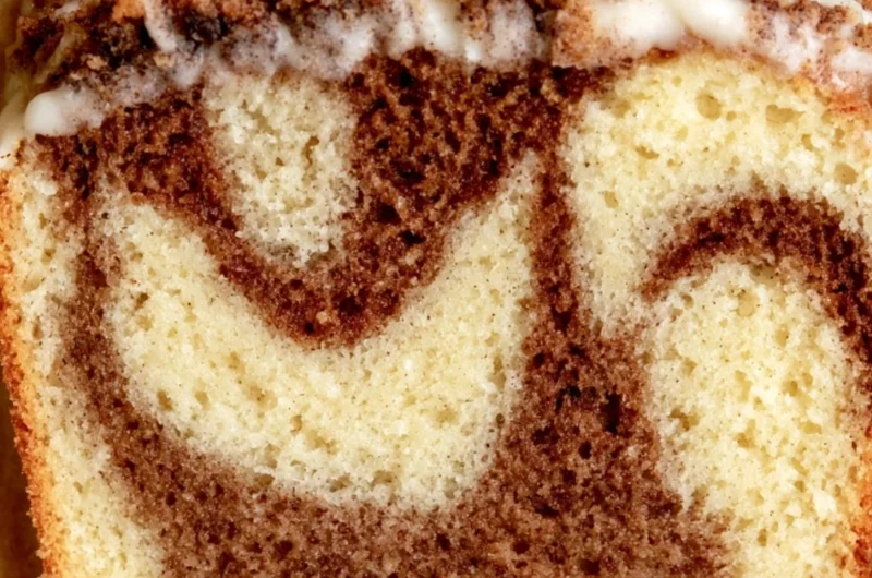 Deliciously baked cozy cinnamon loaf cake garnished with cinnamon sticks.