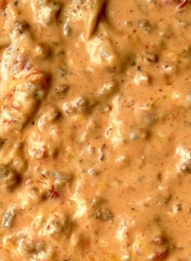 Bowl of delicious queso dip with tortilla chips on the side