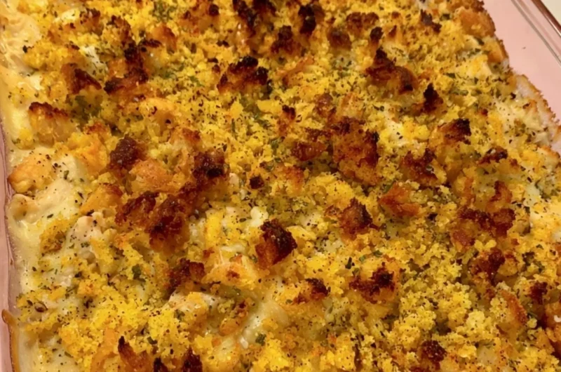 Delicious easy chicken dressing casserole topped with herbs and spices.