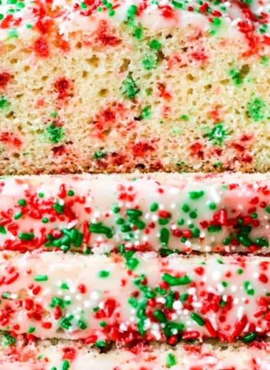Sliced festive Christmas sprinkle buttermilk bread decorated with colorful sprinkles.