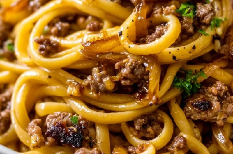A delicious plate of Garlic Butter Beef Pasta garnished with parsley.