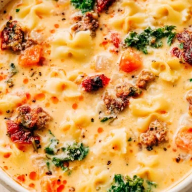 Warm bowl of Italian sausage pasta soup garnished with fresh herbs