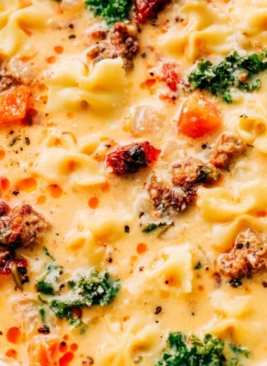 Warm bowl of Italian sausage pasta soup garnished with fresh herbs