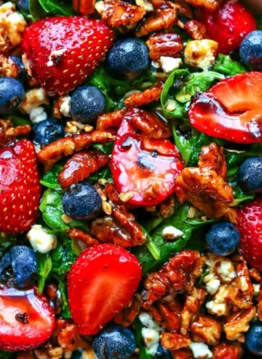 Delicious strawberry spinach salad with blueberries, pecans, and feta cheese