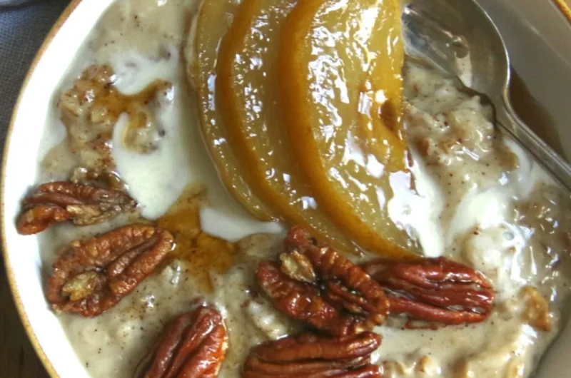 Delicious bowl of chai spiced pear porridge topped with fresh pears and spices