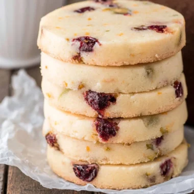 Cranberry Pistachio Shortbread cookies arranged on a plate.