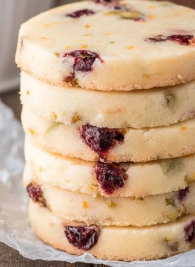 Cranberry Pistachio Shortbread cookies arranged on a plate.
