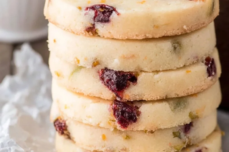 Cranberry Pistachio Shortbread cookies arranged on a plate.