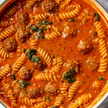 Bowl of creamy Italian meatball soup with fresh herbs and crusty bread