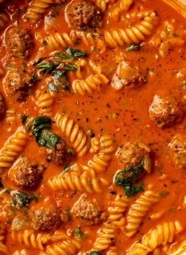 Bowl of creamy Italian meatball soup with fresh herbs and crusty bread