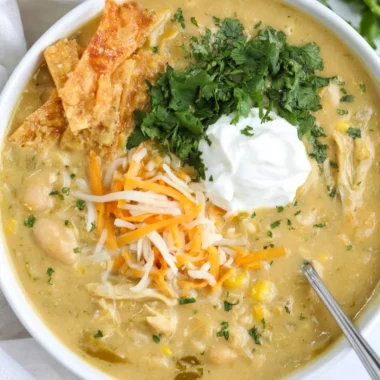 Bowl of easy green enchilada chicken soup topped with cilantro and lime