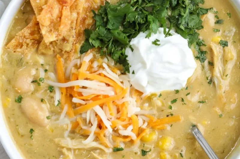 Bowl of easy green enchilada chicken soup topped with cilantro and lime