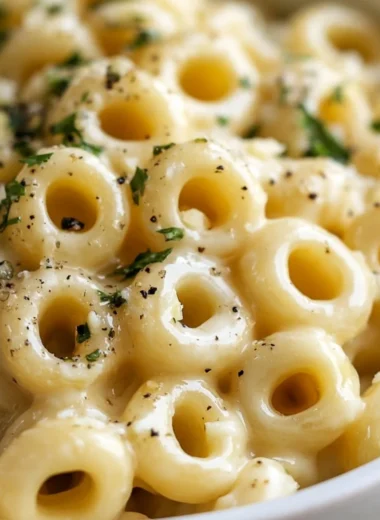 Plate of Garlic Butter Pasta garnished with parsley and grated cheese