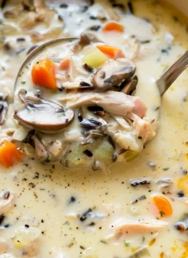 Bowl of homemade leftover turkey wild rice soup with fresh herbs